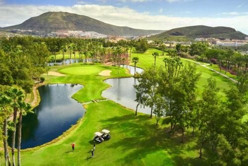 an aerial view of a golf course with a lake at Prime garden-view Studios in Arona