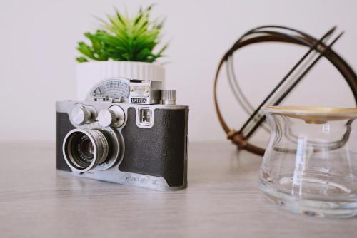 a camera sitting on a table next to a vase at Centrally Located! Remodeled! Huge Backyard! The White House in Albuquerque