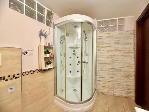 a shower with a glass door in a bathroom at OPEN SPACE Littoria in Latina