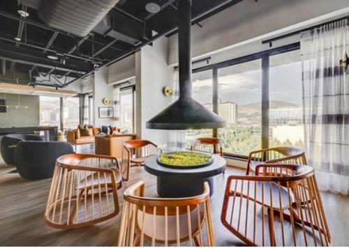 a room with a table and chairs and a large window at Salt City Getaway in Salt Lake City