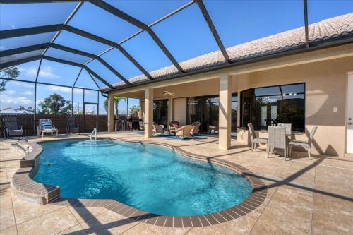 a swimming pool in a house with a glass roof at Cape Coral Private Pool Vacation Home in Matlacha