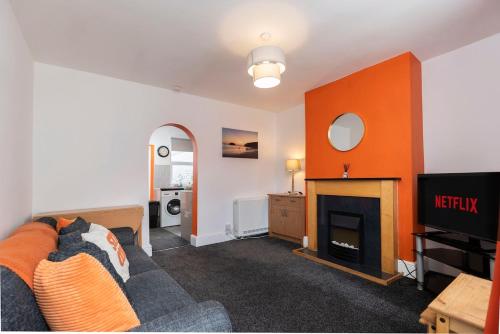a living room with a couch and a fireplace at The Terrace by the Market in Guisborough
