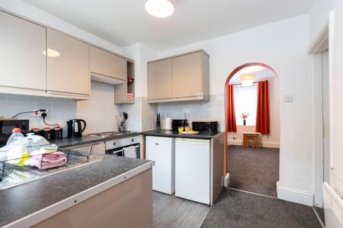 a kitchen with white cabinets and a counter top at The Terrace by the Market in Guisborough