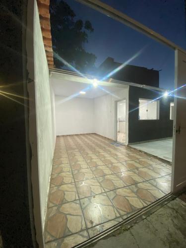 an empty room with lights on the side of a house at Casa a 400m do Mar - O endereço correto é o Rua Rubens Marcus Rocha 541 Jd Jamaica Itanhaem in Itanhaém