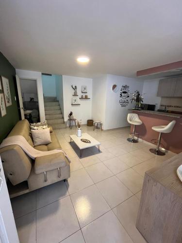 a living room with a couch and a table at CASA HOTEL FLOR DEL VALLE in Cali