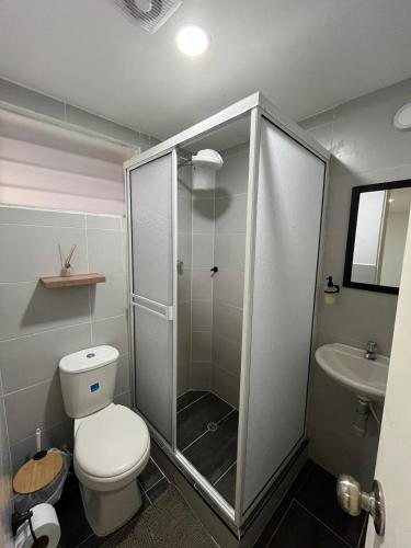 a bathroom with a shower and a toilet and a sink at CASA HOTEL FLOR DEL VALLE in Cali