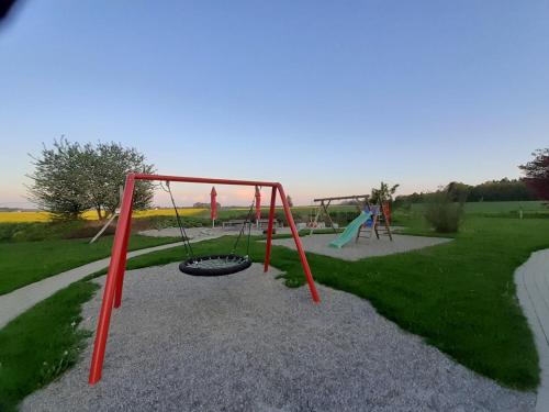 a playground with two swings and a swing at Ferienwohnung 10 in Ochsenhausen