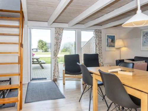 a living room with a table and chairs at 6 person holiday home on a holiday park in Hemmet in Hemmet
