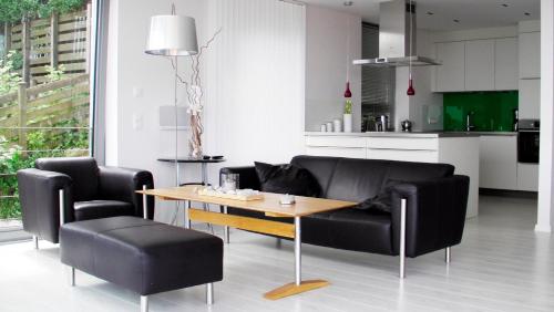 a living room with a couch and a table and chairs at Triton Suite in Eckernförde