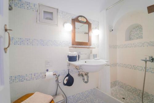 a bathroom with a sink and a toilet and a shower at Spitia Tzitzi in Imerovigli