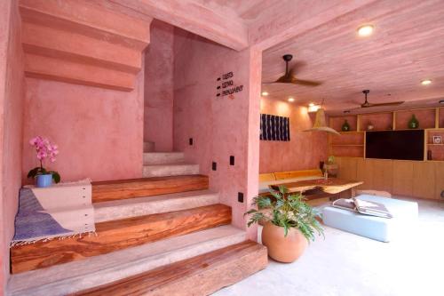 a room with wooden stairs in a house at Casa Malagua Hotel Boutique in Puerto Escondido