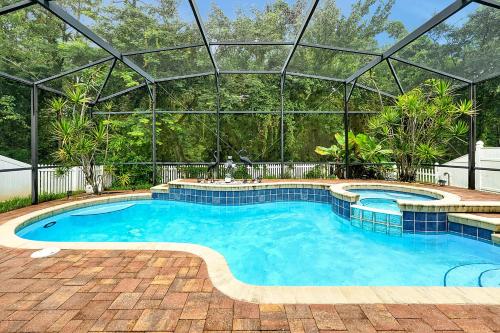 a large swimming pool with a glass roof at 11326 CYPRESS TRAIL DRIVE ORLANDO 3BED in Orlando