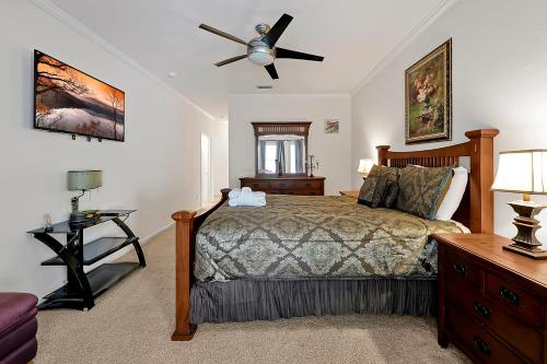 a bedroom with a bed and a ceiling fan at 11326 CYPRESS TRAIL DRIVE ORLANDO 3BED in Orlando
