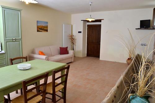 a living room with a table and a couch at Casale di Gualdo in Gualdo di Macerata