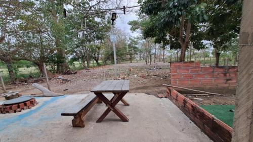 a wooden picnic table sitting in a park at DONDE...MONIK in Arboletes