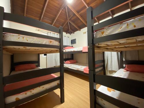 a group of bunk beds in a room at Imana Hostel in Florianópolis