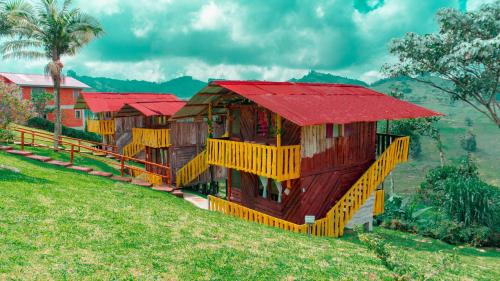 a row of houses with red roofs on a hill at Cabañas/glamping monaco in Santa Rosa de Cabal