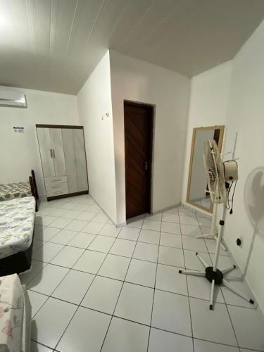 a room with a room with a fan on the floor at Casa Em Pirangi Praia - RN in Parnamirim