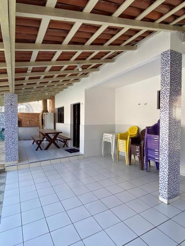 a living room with a table and chairs at Casa Em Pirangi Praia - RN in Parnamirim