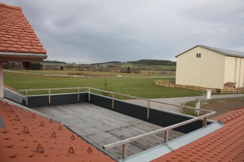 a deck on top of a house with a field at Ferienwohnung Balkon in Bräunlingen