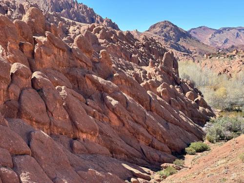a rocky hillside with red rocks in the desert at Dar Mezyana Dades in Aït Idaïr