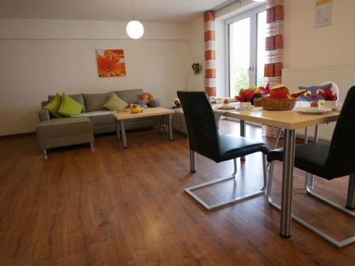a living room with a couch and a table at Ferienwohnung 1 in Ochsenhausen