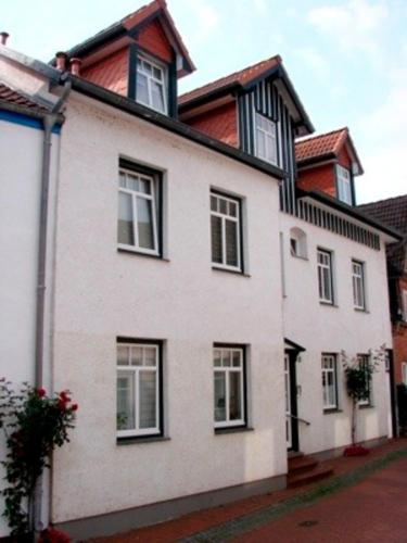 a white house with black windows on a street at Ferienwohnung "Humburg", Strand und Stadt in Eckernförde