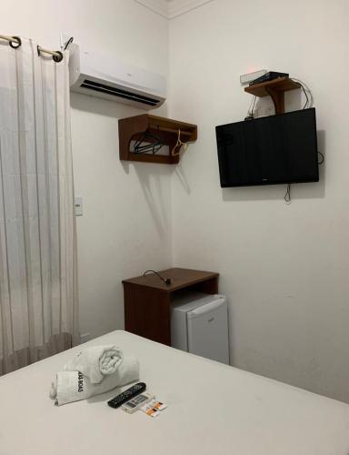 a room with a white counter top and a television at Pousada Vilas Boas in Barreirinhas