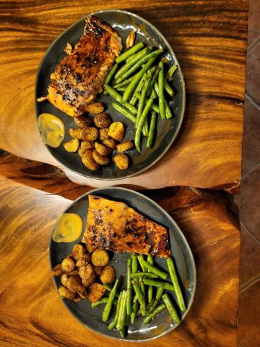 two plates of food with meat and vegetables on a table at Hacienda en Los Volcanes in Hacienda Guayabo