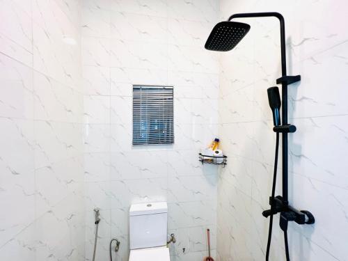 a light in a bathroom with a toilet at Fabulous 2 Bedroom Flat in Iju Junction