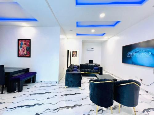 a living room with couches and a table at Fabulous 2 Bedroom Flat in Iju Junction