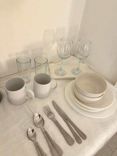 a table with plates and glasses and silverware on it at 1 bed accommodation in Bury