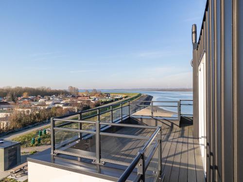 a balcony of a building with a view of the water at Penthouse in Sint-Annaland by the Beach in Sint Annaland