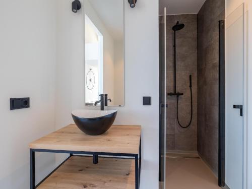 a bathroom with a bowl sink and a shower at Penthouse in Sint-Annaland by the Beach in Sint Annaland