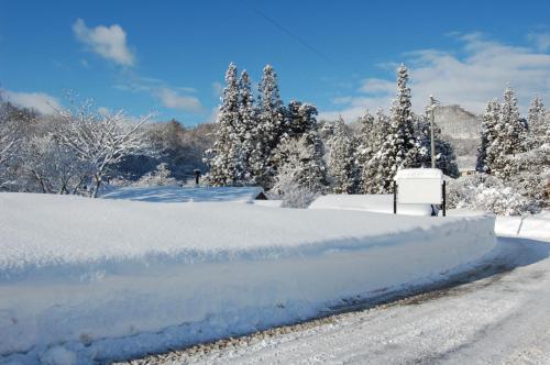 a pile of snow on the side of a road at GETO House in Washiaimori