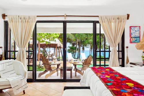 a bedroom with a bed and a view of the ocean at Casa Vista al Mar Isla Mujeres in Isla Mujeres