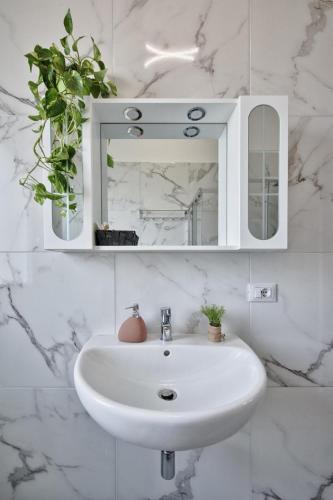 a bathroom with a white sink and a mirror at La Venezia Station Residence Mestre in Mestre