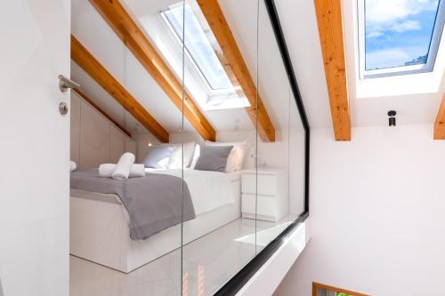 a room with a bed and a glass wall at Apartments by the sea Pucisca, Brac - 23445 in Pučišća