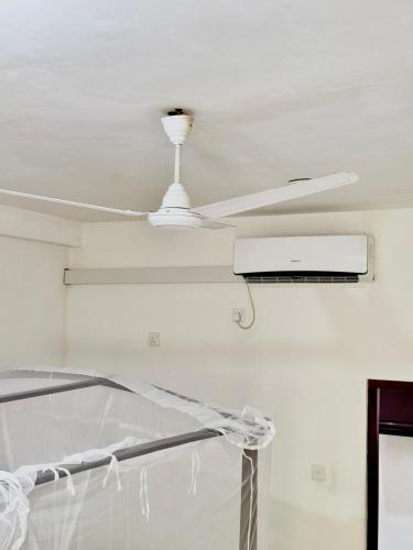 a white ceiling fan in a room at Modern Tiny House in Weligama