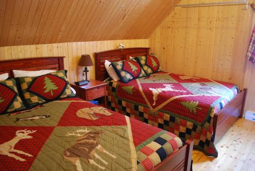 Кровать или кровати в номере Auberge de la Rivière Matapédia - Matapédia River Lodge