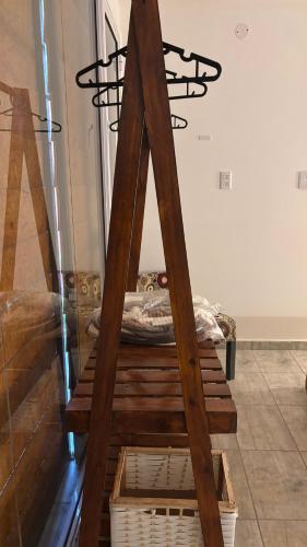 a wooden ladder in a room with a bed at Brisas Rumipal dúplex premium Villa Rumipal in Villa Rumipal