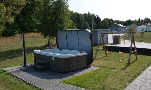 a hot tub in a yard with a swing at Rieke in Malchow