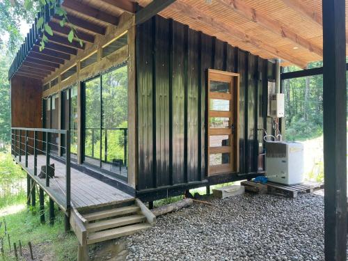 a wooden cabin with a porch and a deck at Cabañas Cerro de Piedra in Pucón