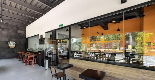 a restaurant with tables and chairs and windows at SaVilie 2 - Seguridad y Comfort - Con Terraza in Guadalajara