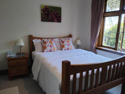a bedroom with a bed with white sheets and a window at LLU Homes in Westport