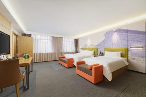 Postel nebo postele na pokoji v ubytování Mehood Hotel Dalian Hi-tech Wanda Plaza Xinghai