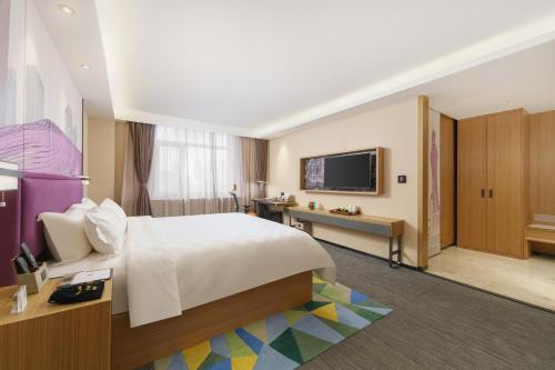 TV a/nebo společenská místnost v ubytování Mehood Hotel Dalian Hi-tech Wanda Plaza Xinghai