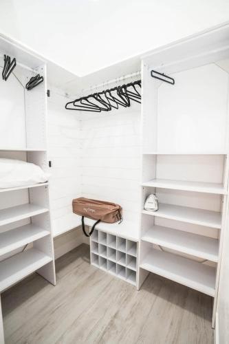 a white closet with white shelves and a wooden floor at Private Dock Heated Pool Hot Tub Game Room Fun in Apollo Beach