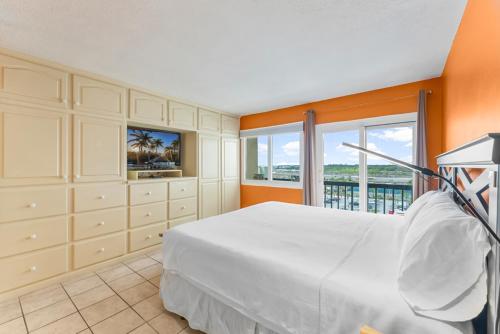 a bedroom with a large bed and a large window at Serenity at A-521 in Panama City Beach