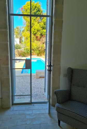 an open door with a view of a swimming pool at ETIS stodio in Khirbet Kafrūrye